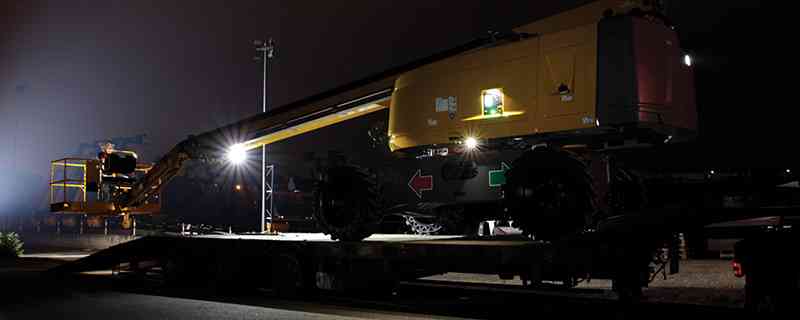 Haulotte HT28 telescopic boom lift includes Active Lighting for safe operation during loadning and unloading at night.